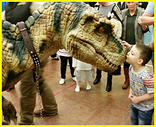 A realistic open legs raptor costume for UK party hire dinosaur party kids party